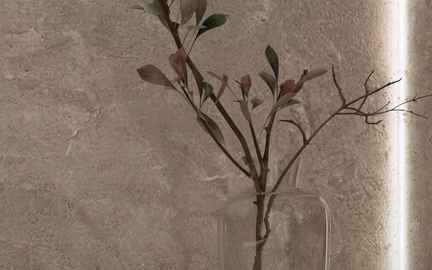 Parede revestida com textura de pedra clara, com um galho seco num vaso